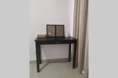 a black desk with a mirror on it in a room at Homestay Tok Ayah, Behrang Jati in Kampung Behrang