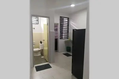 a bathroom with a toilet and a sink and a mirror at Homestay Tok Ayah, Behrang Jati in Kampung Behrang