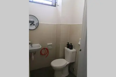 a bathroom with a toilet and a sink at Homestay Tok Ayah, Behrang Jati in Kampung Behrang
