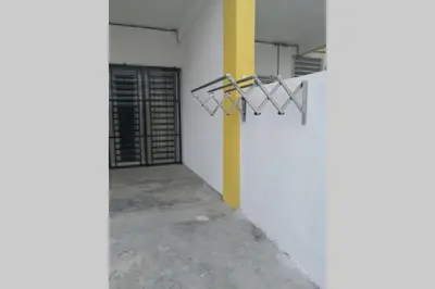 a hallway of a building with a wall with a hanger at Homestay Tok Ayah, Behrang Jati in Kampung Behrang
