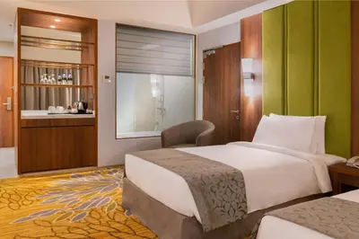 a hotel room with two beds and a window at Zenith Hotel Cameron in Tanah Rata