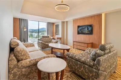 a living room with a couch and chairs and a table at Zenith Hotel Cameron in Tanah Rata
