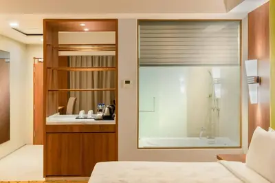 a bedroom with a bathroom with a tub and a sink at Zenith Hotel Cameron in Tanah Rata