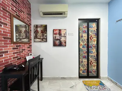 a room with a wall with pictures on the wall at Ipoh Comfortable Rooms Only-Private Bathrooms Indoor Car Parking SY30 in Ipoh