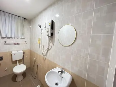 a bathroom with a toilet and a sink and a mirror at Ipoh Comfortable Rooms Only-Private Bathrooms Indoor Car Parking SY30 in Ipoh