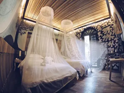 a bedroom with two beds with mosquito nets at The Happy 8 Retreat @ Old Town Ipoh in Ipoh
