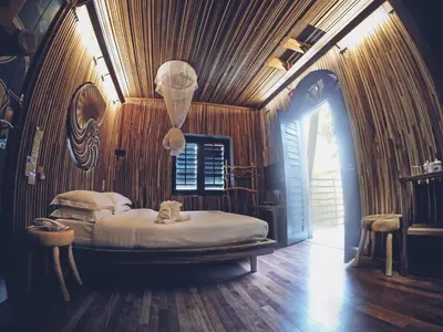 a bedroom with a bed in a room with wooden walls at The Happy 8 Retreat @ Old Town Ipoh in Ipoh