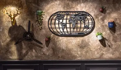 a wall with a cage with antlers and plants on it at Zone Hotel Ipoh in Ipoh