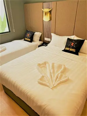 a hotel room with two beds with a heart made out at Zone Hotel Ipoh in Ipoh
