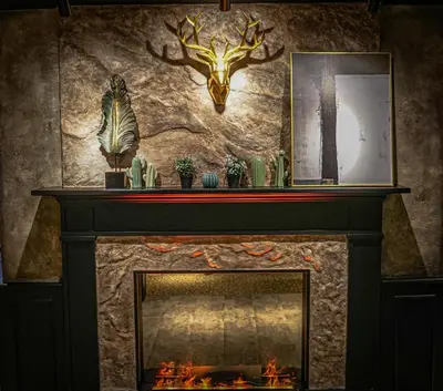 a fireplace with a deer head on the wall at Zone Hotel Ipoh in Ipoh