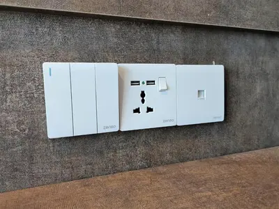 two white electrical switches on a wall at Zone Hotel Ipoh in Ipoh