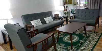 a living room with a couch and chairs and a table at RAHIM HOMESTAY KUALA KANGSAR in Kuala Kangsar