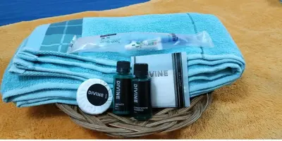 a basket with a blue towel and some products on it at RAHIM HOMESTAY KUALA KANGSAR in Kuala Kangsar