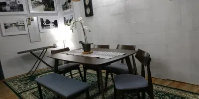 a dining room table with chairs and a lamp at RAHIM HOMESTAY KUALA KANGSAR in Kuala Kangsar