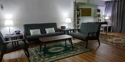 a living room with a couch and chairs and a table at RAHIM HOMESTAY KUALA KANGSAR in Kuala Kangsar