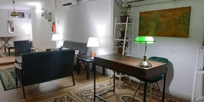 a room with a table and chairs and a desk at RAHIM HOMESTAY KUALA KANGSAR in Kuala Kangsar