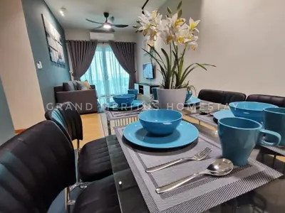 a dining room table with blue dishes on it at Grand Meritus Homestay @Penang in Perai