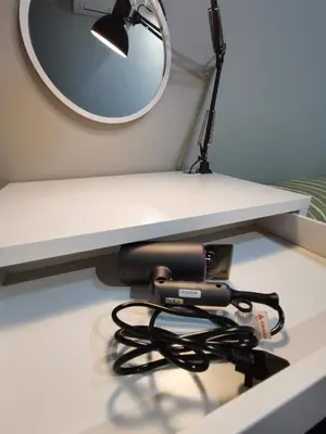 a hair dryer sitting under a desk with a mirror at Grand Meritus Homestay @Penang in Perai
