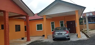 a small car parked in front of a house at Nurul Saadah Lunas in Lunas