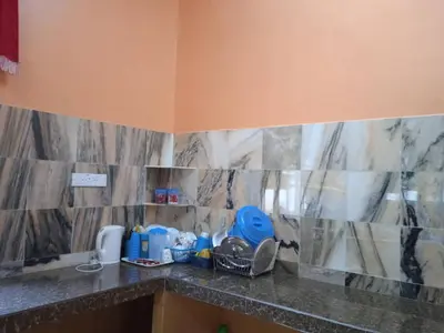 a kitchen with a counter top with a sink at Enalys Homestay untuk orang islam sahaja in Kampung Bota Kiri