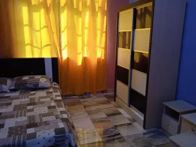 a bedroom with a bed and a dresser at Enalys Homestay untuk orang islam sahaja in Kampung Bota Kiri