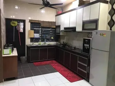 a kitchen with a white refrigerator and a black counter top at No 96 Nazirin Homestay Lumut in Lumut