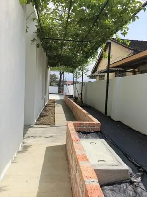 an empty alley way with trees and a building at Garden Home Ipoh in Ipoh