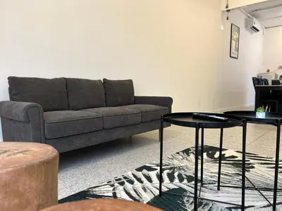 a living room with a couch and two tables at Garden Home Ipoh in Ipoh