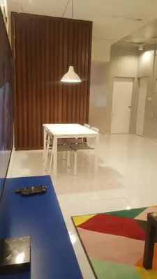a white table in an empty room with a table at Tulip Hotel in Ipoh