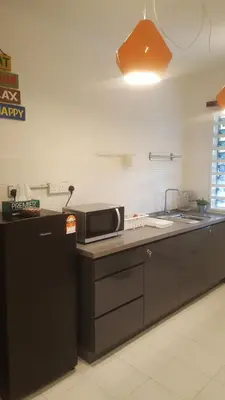 a kitchen with a sink and a microwave at Tulip Hotel in Ipoh