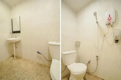 a bathroom with a toilet and a phone on the wall at JMA FERRINGHI BEACH HOTEL in Batu Ferringhi