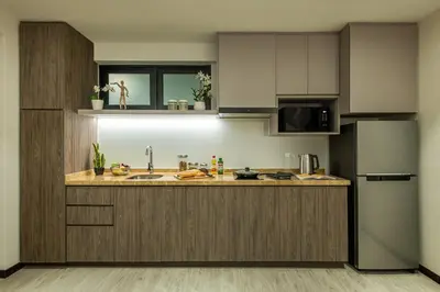 a kitchen with a sink and a refrigerator at Citadines Prai Penang in Bukit Mertajam