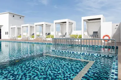 a swimming pool in front of a villa at Citadines Prai Penang in Bukit Mertajam
