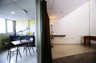 a room with a table and chairs and a dining room at Private Beanie (Private Cinema, Swing & more) at CEO Penang in Bayan Lepas