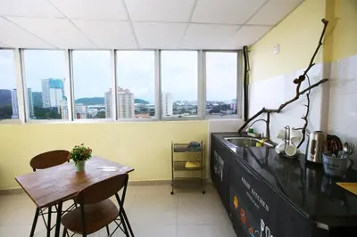 a kitchen with a counter and a table and some windows at Private Beanie (Private Cinema, Swing & more) at CEO Penang in Bayan Lepas