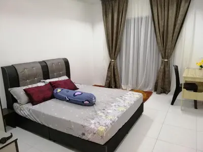 a bed with purple pillows in a room at Onies Homestay Lumut Manjung in Lumut