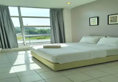 a bedroom with a large bed with a large window at 1108 Hotel Sungkai in Sungkai