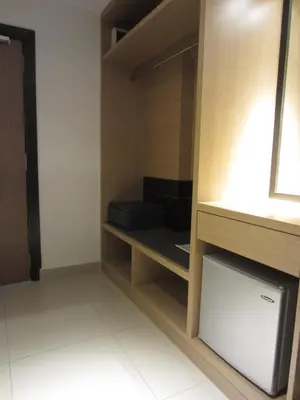 a room with a closet with a couch in it at D Hotel in Seri Iskandar