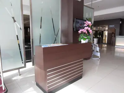 a lobby with a counter with flowers on it at D Hotel in Seri Iskandar