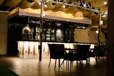 a dining room with chairs and a table and a bar at Armenian Street Heritage Hotel in George Town
