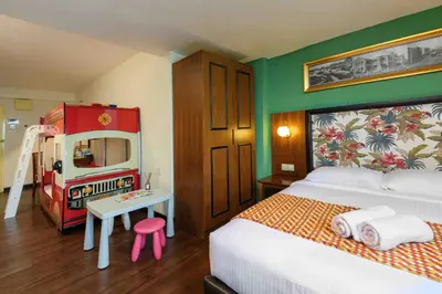a bedroom with a bed and a table with a desk at Armenian Street Heritage Hotel in George Town