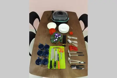 a table with scissors and other utensils on it at W58 WarmStay atGoldenHill NightMarket 2R WiFi CarPark in Tanah Rata