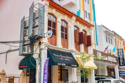a building with a clock on the side of it at Bishop Hotel in George Town