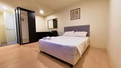 a bedroom with a large white bed in a room at Bishop Hotel in George Town