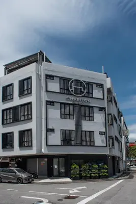 a large white building with a sign on it at Chariton Hotel Bagan in Butterworth