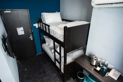 a room with two bunk beds in a room at Chariton Hotel Bagan in Butterworth