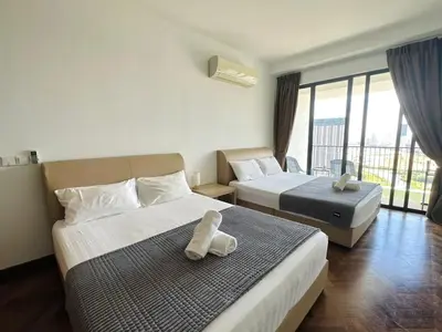 a hotel room with two beds with a teddy bear on it at Landmark Stunning High Floor Coast View Studio #Netflix #Fast Wifi in Tanjong Tokong