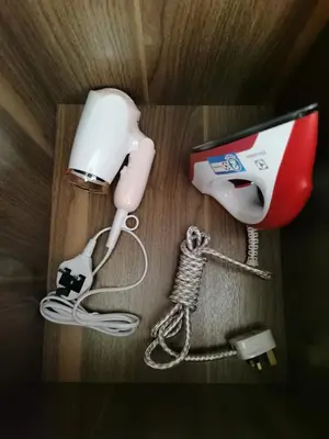 a cell phone hooked up to a hair dryer at Landmark Stunning High Floor Coast View Studio #Netflix #Fast Wifi in Tanjong Tokong
