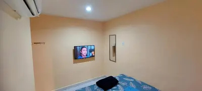a bedroom with a tv on the wall and a bed at RELAX HOTEL in Sungai Petani