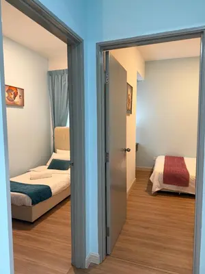 a room with a bed and a sliding glass door at Mama King’s Homestay@ Palas Horizon in Brinchang